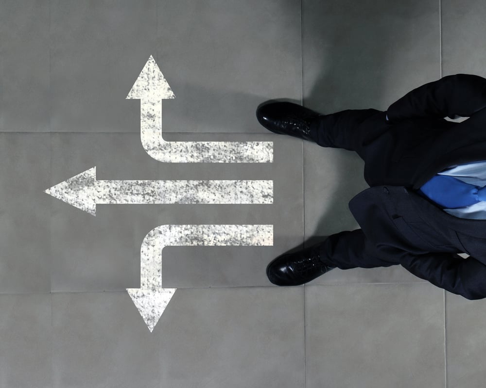 Top view of businessman standing against directions background